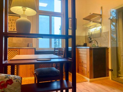 a kitchen with a desk and a table in a room at Mini-Appartements am Burgberg in Bad Harzburg