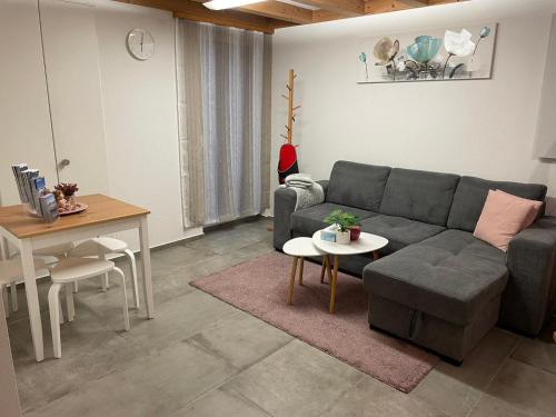 a living room with a couch and a table at Wohnung am Postweg in Netstal