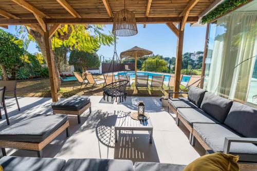 a patio with a couch and chairs and a table at Casa Rio Real Marbella in Marbella