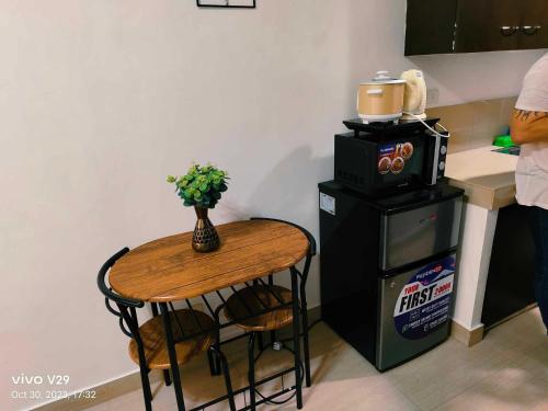 a kitchen with a table and a small table with a blender at Jenny N Rose Travellers Inn in Manila