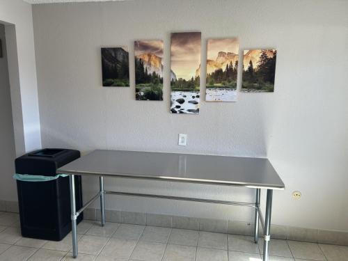 a table in a room with paintings on the wall at Days Inn by Wyndham Turlock in Turlock