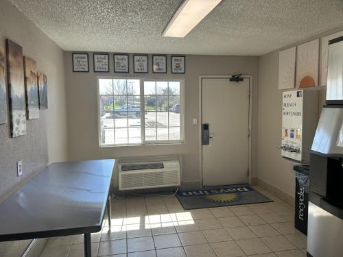 a room with a kitchen with a window and a refrigerator at Days Inn by Wyndham Turlock in Turlock