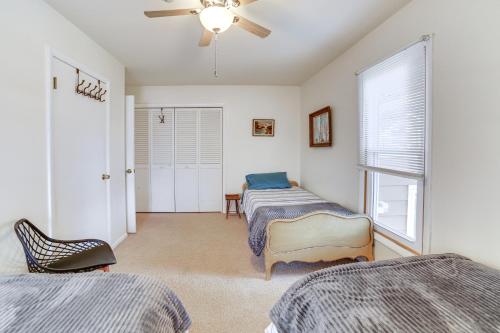 a bedroom with two beds and a ceiling fan at Private Beach and Deck Spacious Lake Michigan Home in Menominee