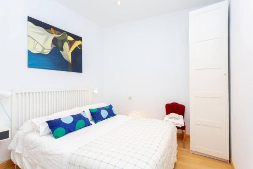 1 dormitorio blanco con 1 cama y una pintura en la pared en One bedroom appartement with wifi at Madrid, en Madrid