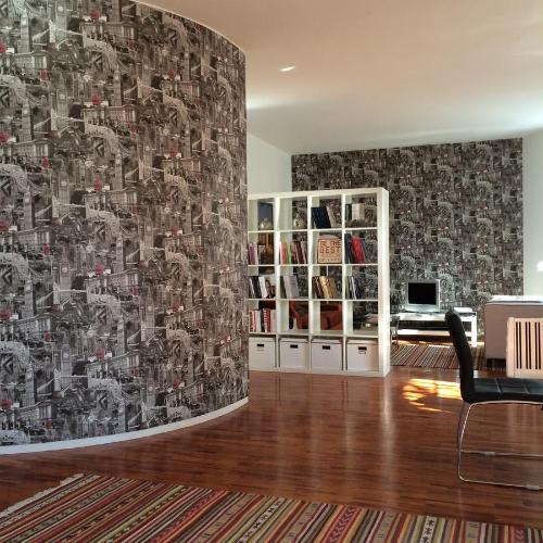 a living room with a wall with a wallpaper at Belong Staying and Feeling - Casa da Sé in Lisbon