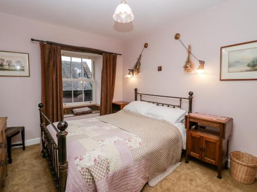 a bedroom with a bed and a window at Eden Vale in Broughton in Furness