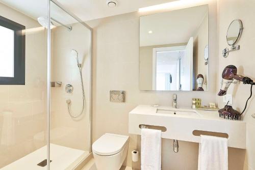 a bathroom with a toilet and a sink and a shower at Eurostars Ibiza in Ibiza Town