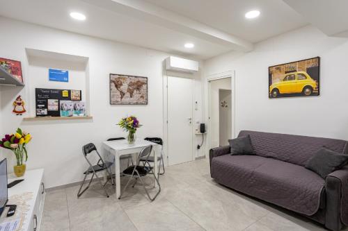 a living room with a couch and a table at Petite House Frascati in Frascati