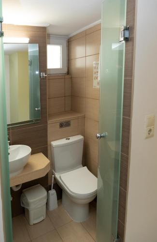 a bathroom with a toilet and a sink at Kronos Hotel in Heraklio Town