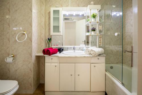 a bathroom with a sink and a toilet and a shower at 3 bedrooms appartement at Calafell 5 m away from the beach with sea view terrace and wifi in Calafell