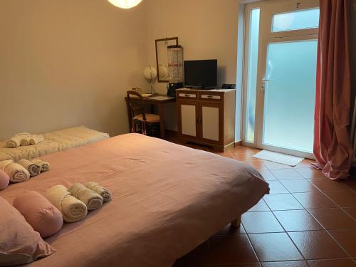 a bedroom with two beds and a desk and a window at Da Francesca in Lucca