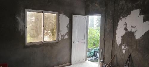 an empty room with an open door and a window at Quinta de Monte luso in São Filipe