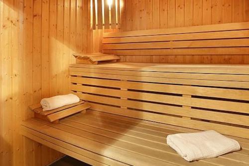 a wooden sauna with two white towels in it at Chalet Pura Vida Morillon Samoëns Grand Massif 6-8 in Morillon