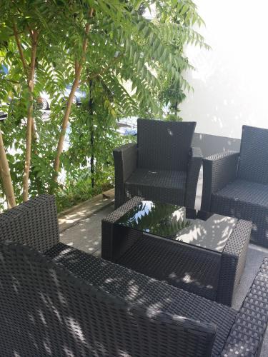 a group of chairs and tables on a patio at HD City Apartments in Heidelberg