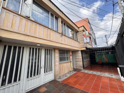 un edificio con una puerta delante de él en Hostel Bogotá Normandia VIP, en Bogotá