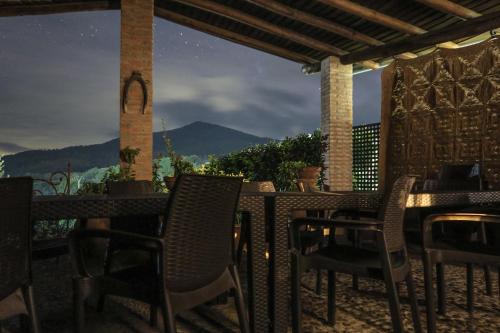 a porch with chairs and a table with a view at Casa El Descanso Del Peregrino in Guadalupe