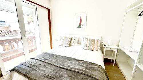 a white bedroom with a bed and a window at Suit Dreams Vilaflor By Deihu Experiences in Vilaflor