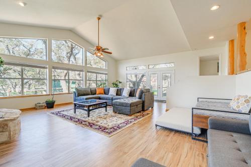 a living room with a couch and a table at Pin Oak Farmhouse with Patio in Dripping Springs in Dripping Springs