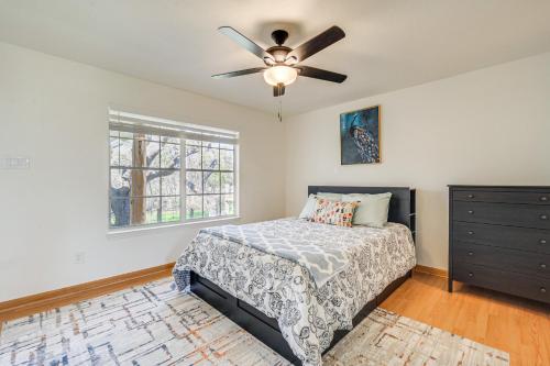 a bedroom with a bed and a ceiling fan at Pin Oak Farmhouse with Patio in Dripping Springs in Dripping Springs