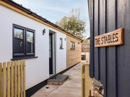 a house with a sign that reads the sticks at The Stables Merrydown in Axminster