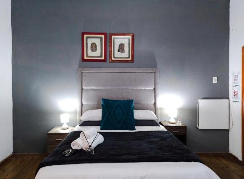 a bedroom with a large bed with two lamps on it at Leana Hub Guest House in Potchefstroom