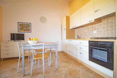a kitchen with a table and chairs and a stove at [Olbia 15 minutes] Enchanting sea view in Olbia