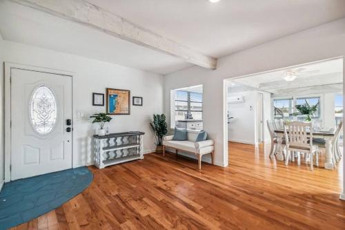 an empty living room with a table and a chair at Hernando Hideaway:Heated Pool/Decks/Dock/Balcony/Yard w/ Firepit/Kayaks in Hernando Beach