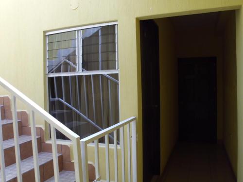 a door to a room with a staircase next to a building at Crysol Center Hotel in Chimaltenango