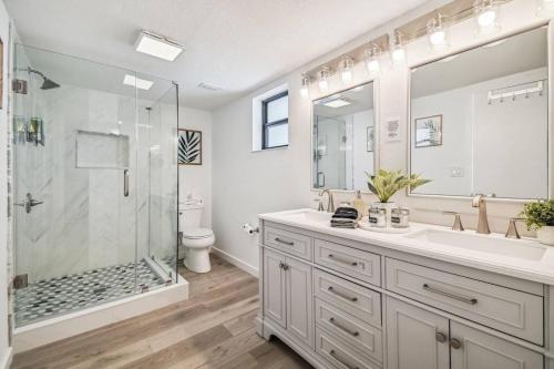 a bathroom with a shower and a sink and a toilet at Hernando Hideaway:Heated Pool/Decks/Dock/Balcony/Yard w/ Firepit/Kayaks in Hernando Beach