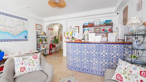 a room with a counter with a blue and white pattern at Guest House Dianamar in Albufeira