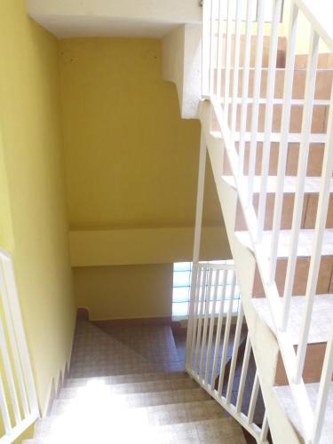 a staircase in a house with yellow walls at Crysol Center Hotel in Chimaltenango