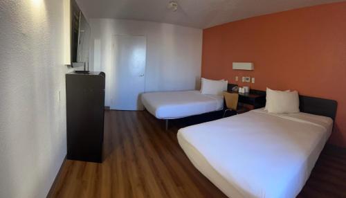 a hotel room with two beds and a small room with at Motel 6-Austin, TX - North Central in Austin