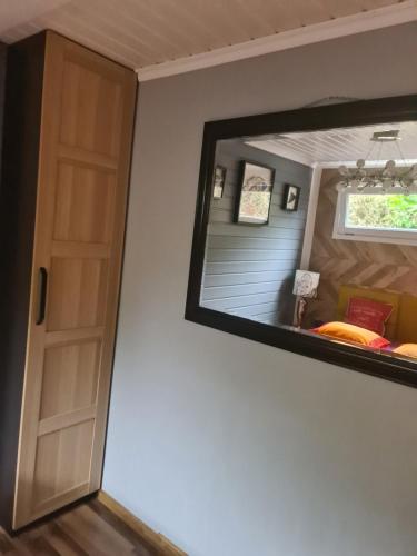 a mirror in a room with a bed and a window at Camping - Park Władysławowo in Władysławowo