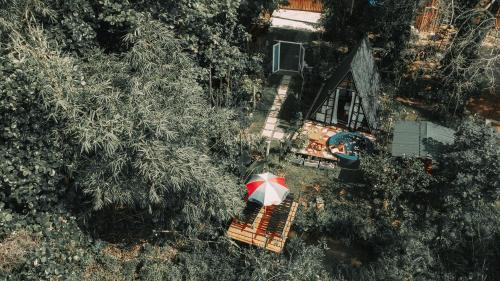 an overhead view of a person with a red and white umbrella at The WE2 "Wildwood Elegance Escape" in Induruwa