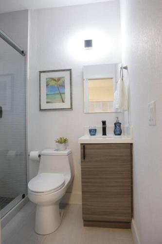 a bathroom with a toilet and a sink at Apt 1 Miami Designer Studio in the Upper East-Side in Miami