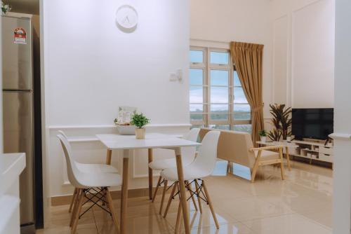 a kitchen and dining room with a table and chairs at Mount Austin Manhanttan Sovo by Cactus Homestay in Johor Bahru