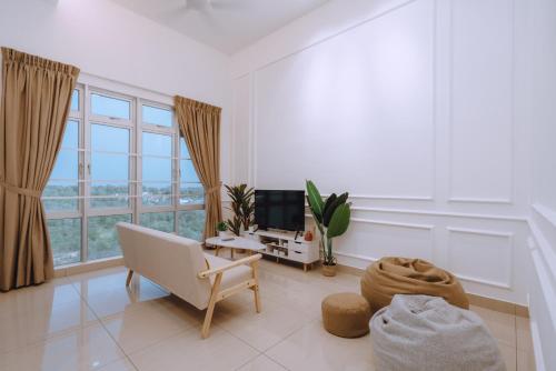 a living room with a chair and a couch and a window at Mount Austin Manhanttan Sovo by Cactus Homestay in Johor Bahru