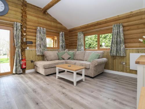 a living room with a couch and a table at Redwood Lodge in Ellesmere