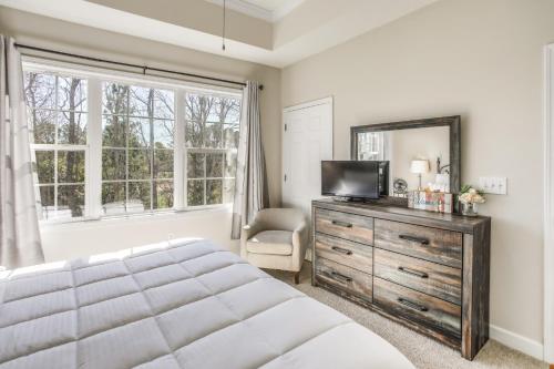 a bedroom with a bed and a mirror and a dresser at Relax at Barefoot Getaway in North Myrtle Beach! in North Myrtle Beach