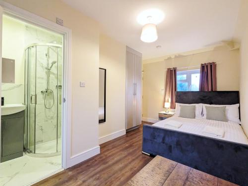 a bedroom with a king sized bed and a shower at Rooms Near City Centre Private Bath Free Parking in York