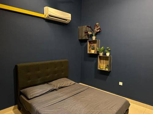 a bedroom with a bed with two plants on the wall at Mount Austin Manhanttan Sovo by Cactus Homestay in Johor Bahru