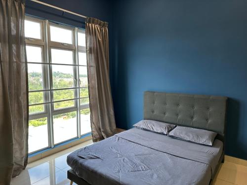 a bedroom with a bed and a large window at Mount Austin Manhanttan Sovo by Cactus Homestay in Johor Bahru