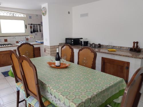 a kitchen with a table with a bottle of wine on it at Villa Vera in Fontane Bianche