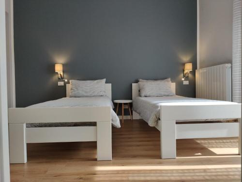 a bedroom with two beds and a table at Bed and Breakfast Cattinara in Trieste