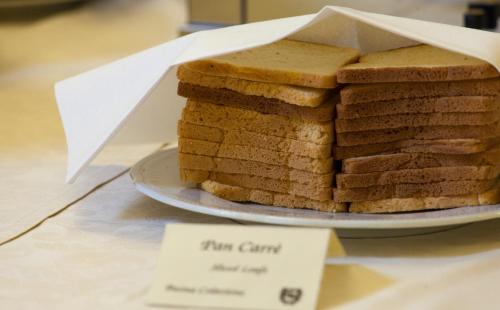 a stack of bread on a plate on a table at Hotel Mamiani & Relaxing Spa Urbino in Urbino