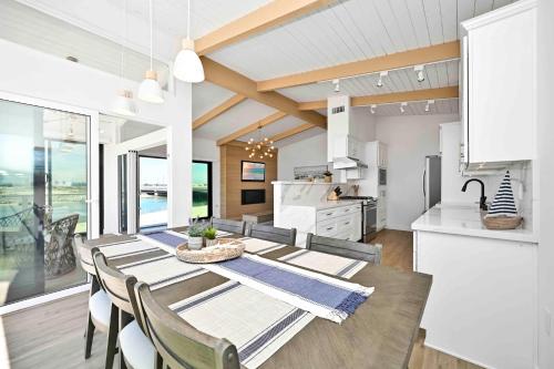 comedor y cocina con mesa y sillas en Immaculate Home with 180 degree views of the Beach & Ocean, en Newport Beach