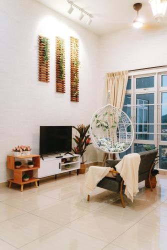 a living room with a tv and a couch at Mount Austin Manhanttan Sovo by Cactus Homestay in Johor Bahru