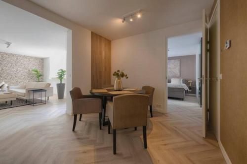 comedor con mesa y sillas y sala de estar en Leon Spacious Apartment With Garden Room 1, en Roosendaal