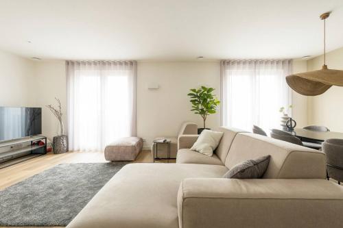 a living room with a couch and a tv at New Apartment In City Centre Large in Oirschot
