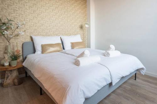 a large white bed with white sheets and pillows at Spacious Apartment Lana, Clean Comfy in Tilburg